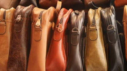 Close up of leather handmade bags on a wall for sale