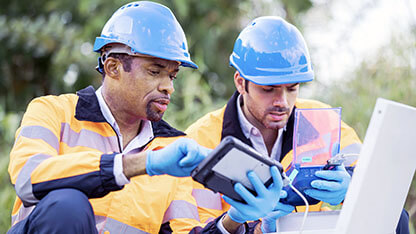 Monitoring and Assessing Vibration Measurement in Construction Industry. Diversity of Team Service Engineers in field operations having a discussion on vibration measuring devices of overall values and spectra data.