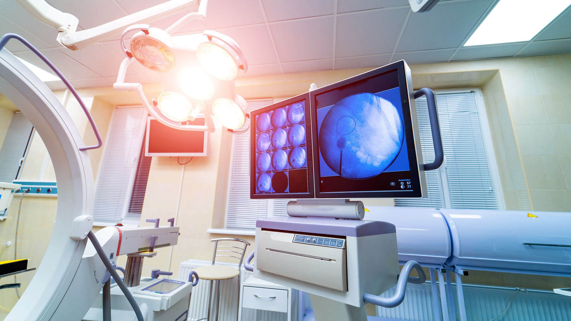 operating room with X-ray medical scan. real modern operating theater with working equipment, lights and computers.