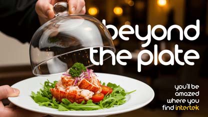 A plate of fresh greens and lobster tails being served in a restaurant