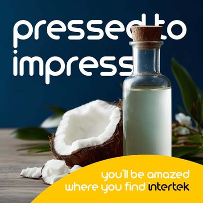 A bottle of coconut milk sitting next to an open coconut