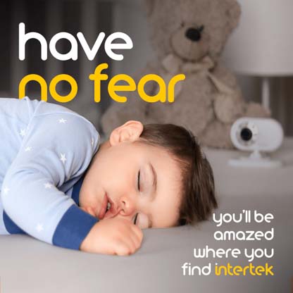 An infant sleeping in a crib next to a monitoring camera