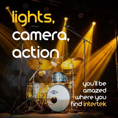 A drum set illuminated by spotlights on a stage